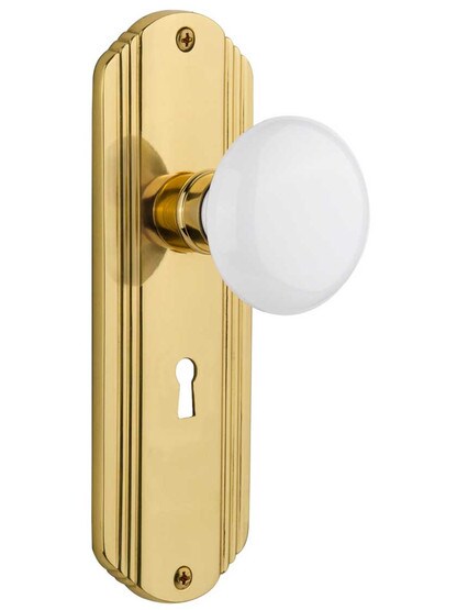 Streamline Moderne Mortise Lock Set With White Porcelain Door Knobs in Un-Lacquered Brass.